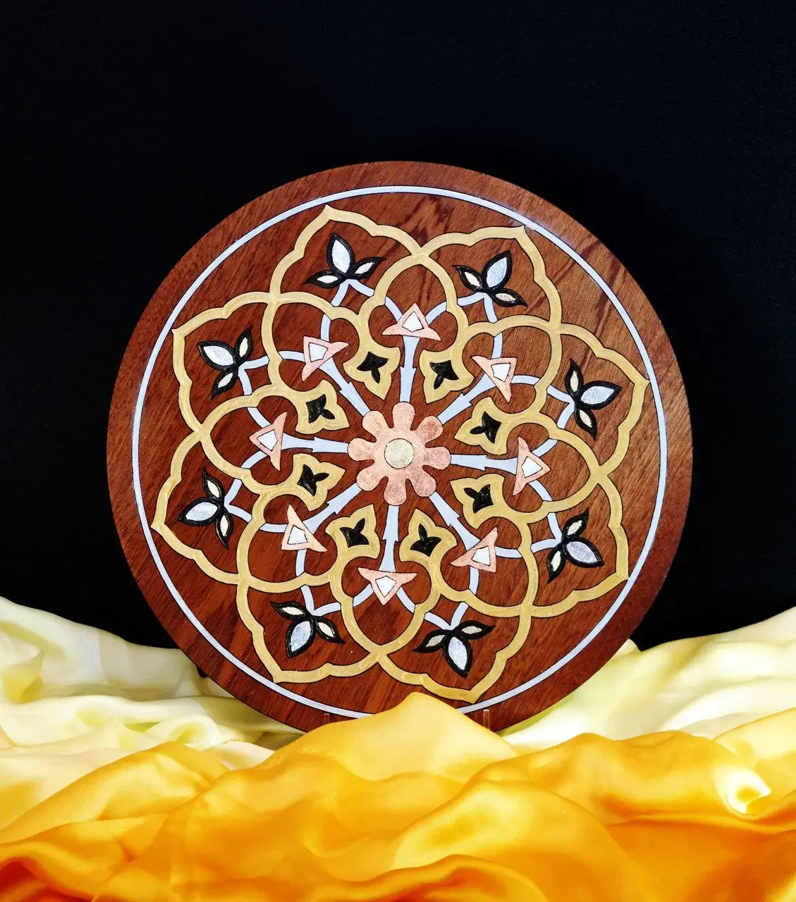 Circular wooden medallion with mirror-inlay Persian sacred geometry in gold and copper.